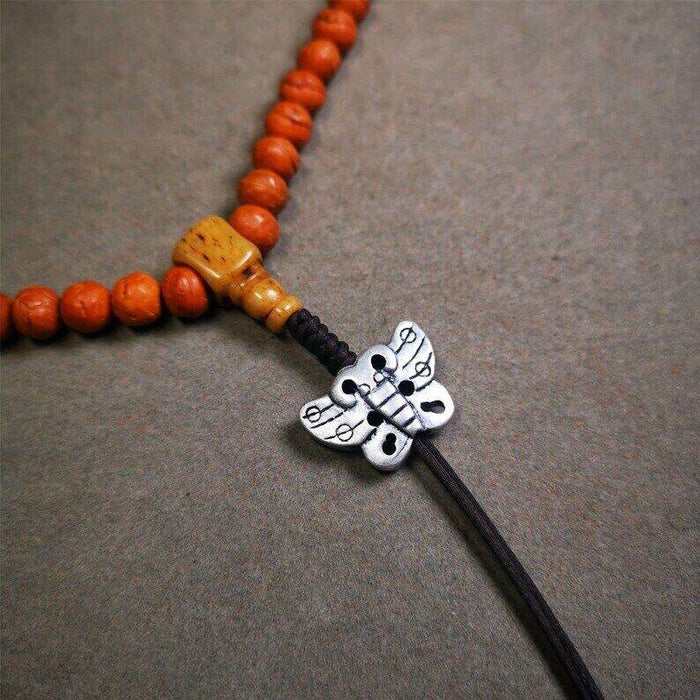Amulet,Pendant for Mala - Tibetan Buddhist mala beads, close-up detail