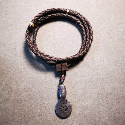 Amulet,Skull Sītavana Flame Pendant Leather Necklace - Tibetan Buddhist bead necklace, close-up detail