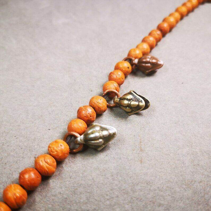 Mala Amulet,Mani Jewel/Wish-Fulfilling Cintamani - Tibetan Buddhist mala beads, close-up detail
