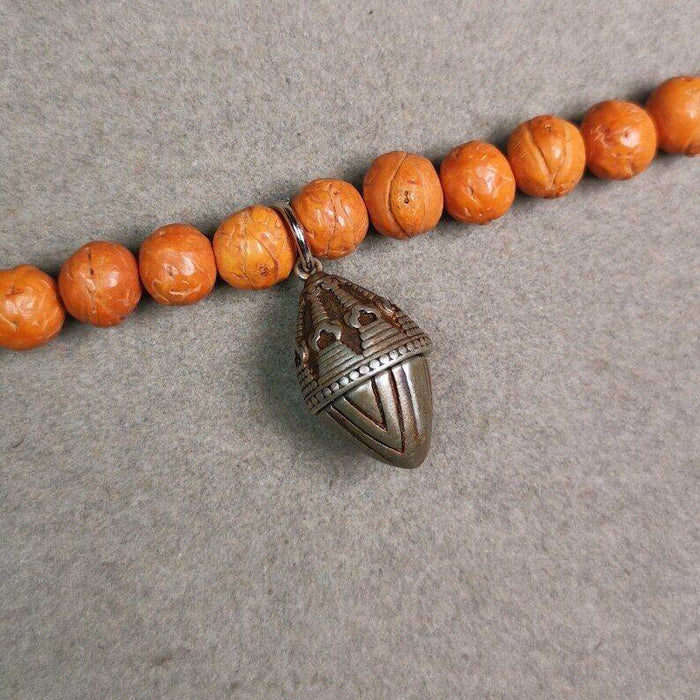 Mala Pendant,Niangla Tsa Tsa Stupa Gau Shrine Amulet - Tibetan Buddhist mala beads, close-up detail
