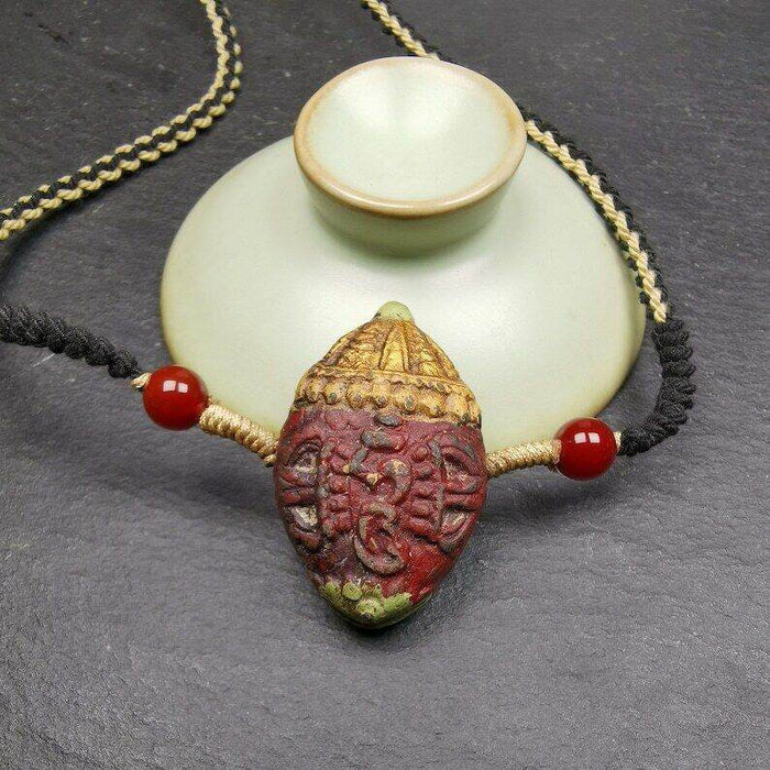 Tibetan Stupa Tsa Tsa Amulet, Double-sided Vajra and Bodhi Leaf Shape Pendant - Tibetan Buddhist amulet, close-up detail