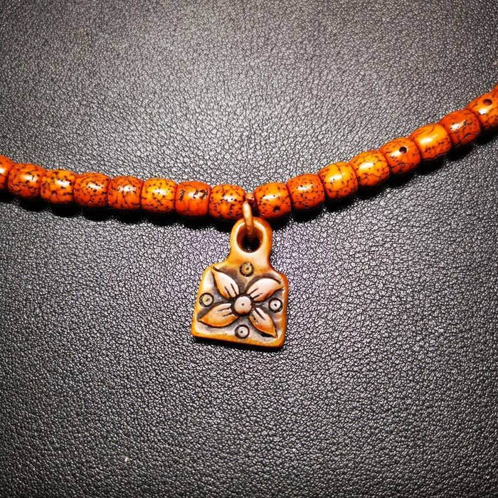 Yak Bone Carved Flower Prayer Bead Pendant - Tibetan Buddhist art, detailed view