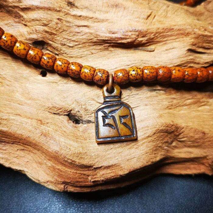 Yak Bone Carved Letter Prayer Bead Pendant - Tibetan Buddhist art, front view