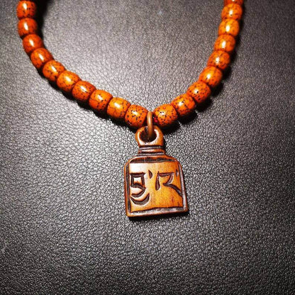 Yak Bone Carved Letter Prayer Bead Pendant - Tibetan Buddhist art, close-up detail