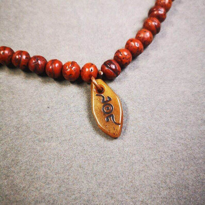 Yak Bone Carved Mani Jewel Prayer Bead Pendant - Tibetan Buddhist art, front view
