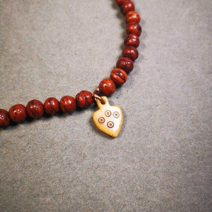 Yak Bone Carved Mantra Dot Prayer Bead Pendant - Tibetan Buddhist art, front view
