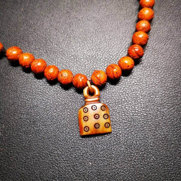 Yak Bone Carved Mantra Dot Prayer Bead Pendant - Tibetan Buddhist art, detailed view
