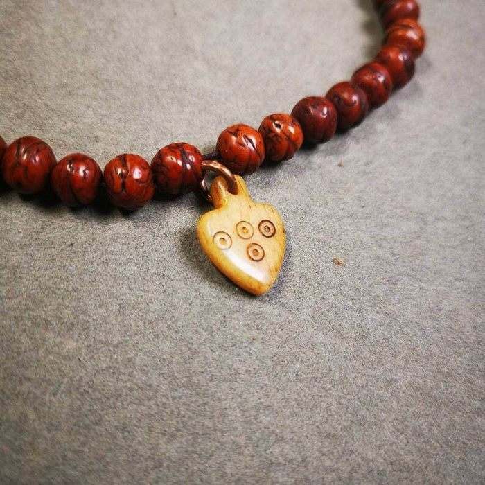 Yak Bone Carved Mantra Dot Prayer Bead Pendant - Tibetan Buddhist art, close-up detail