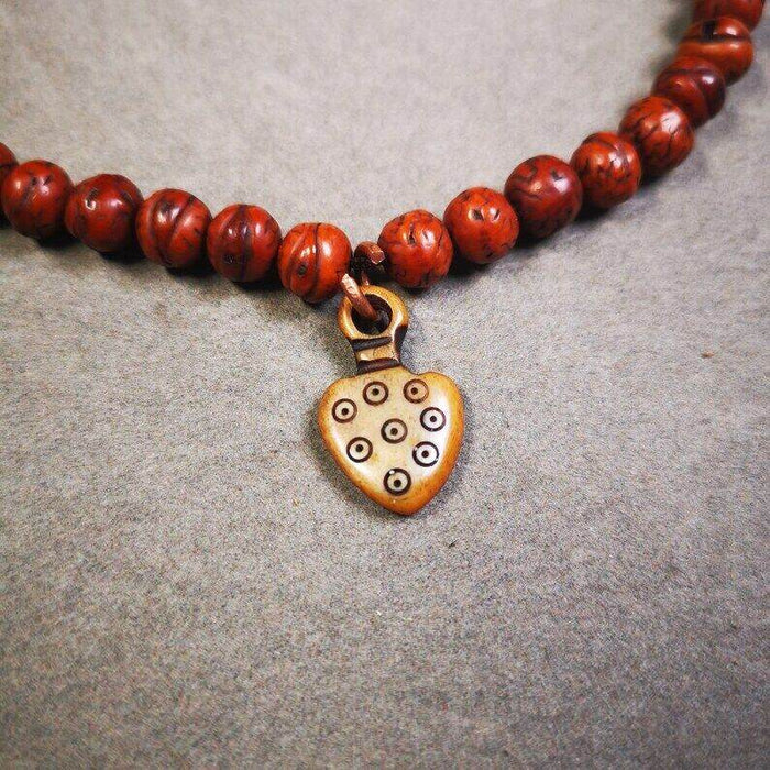 Yak Bone Carved Mantra Dot Prayer Bead Pendant - Tibetan Buddhist art, close-up detail