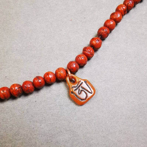 Yak Bone Carved OM Letter Prayer Bead Pendant - Tibetan Buddhist art, front view