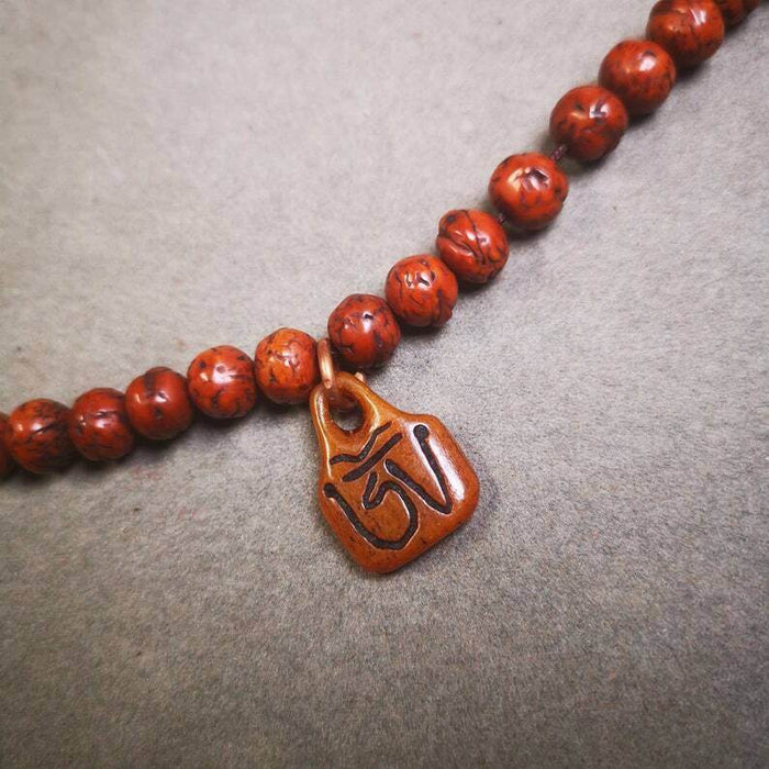 Yak Bone Carved OM Letter Prayer Bead Pendant - Tibetan Buddhist art, detailed view