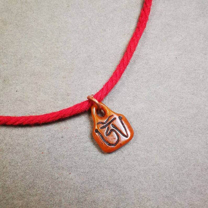 Yak Bone Carved OM Letter Prayer Bead Pendant - Tibetan Buddhist art, close-up detail