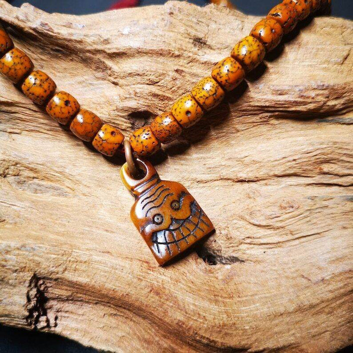 Yak Bone Carved Skull Prayer Bead Pendant - Tibetan Buddhist art, front view