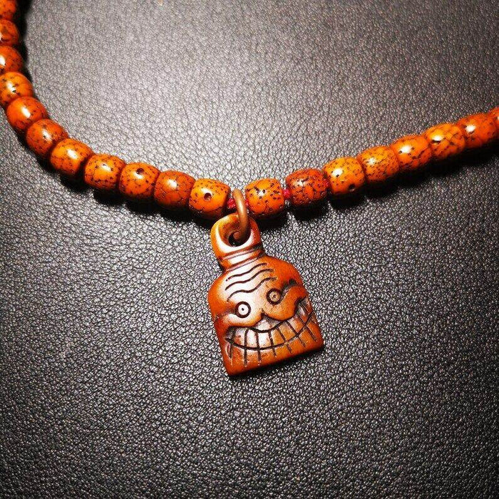 Yak Bone Carved Skull Prayer Bead Pendant - Tibetan Buddhist art, close-up detail
